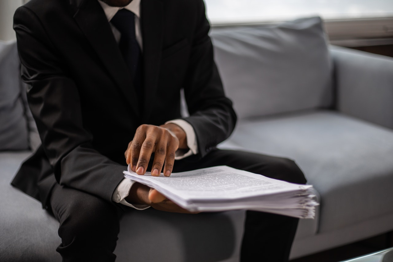 Guy in black suit going through an entire document