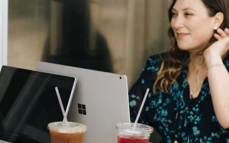 Megan Michelakos, co-Founder of Trebletree sits a her laptop at a cafe