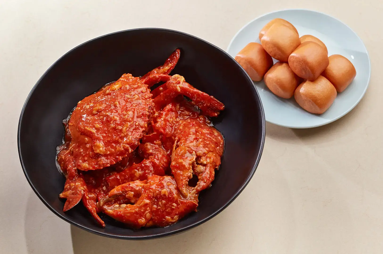 Singapore chili crab with golden buns served as a classic seafood restaurant dish
