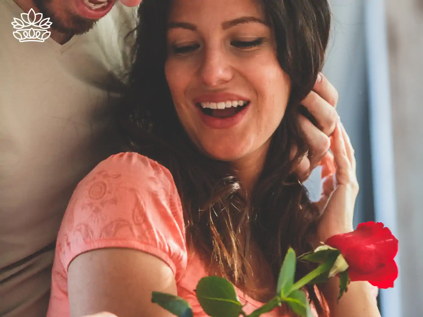 A couple sharing a joyful moment with a single red rose. Fabulous Flowers and Gifts. Flower Delivery to Cape Town Collection.