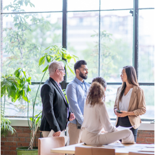 This image shows a group of working professionals in discussion with multiple people speaking at quick successions