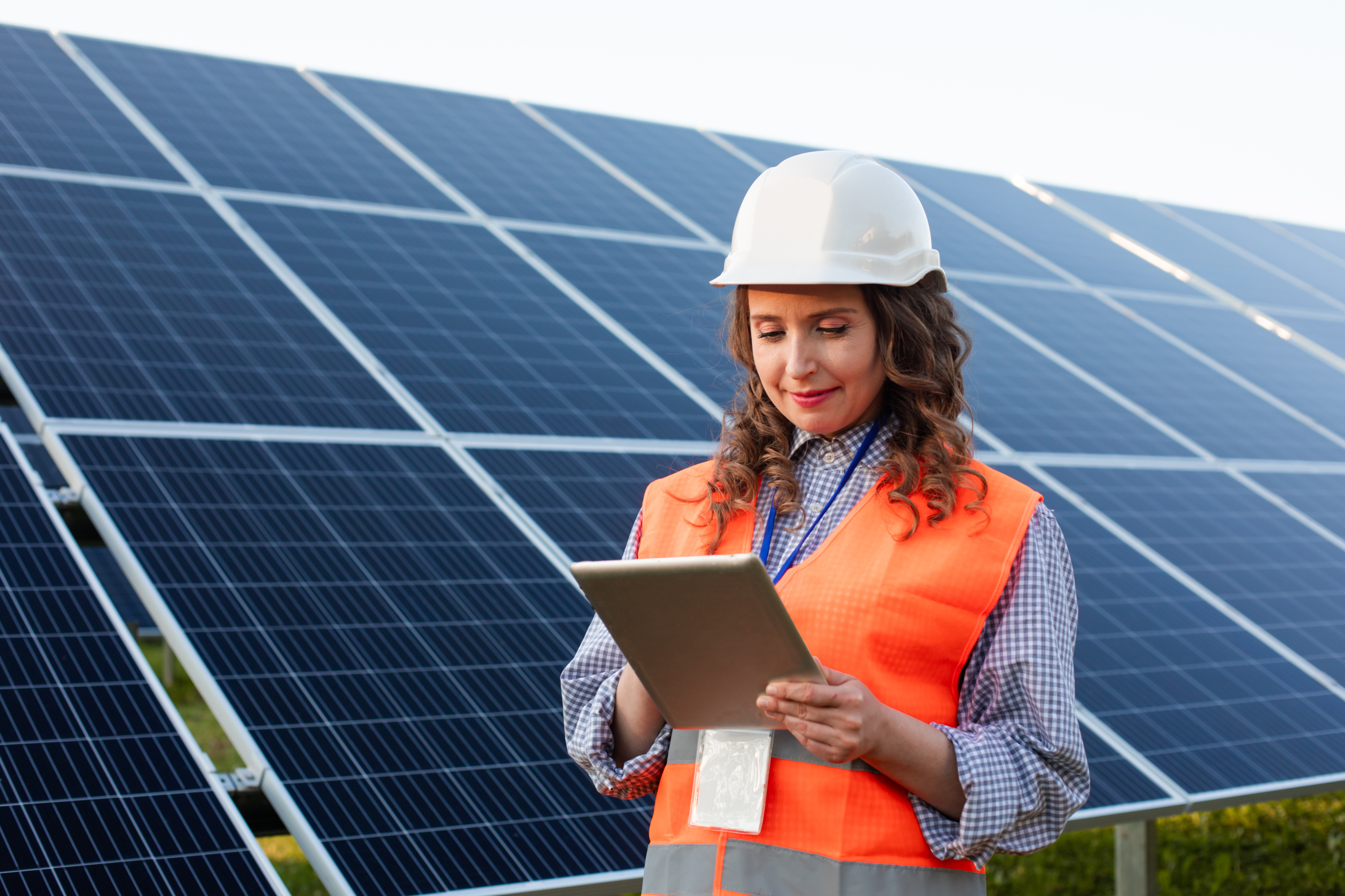 Female engineer is working with tablet at solar station
