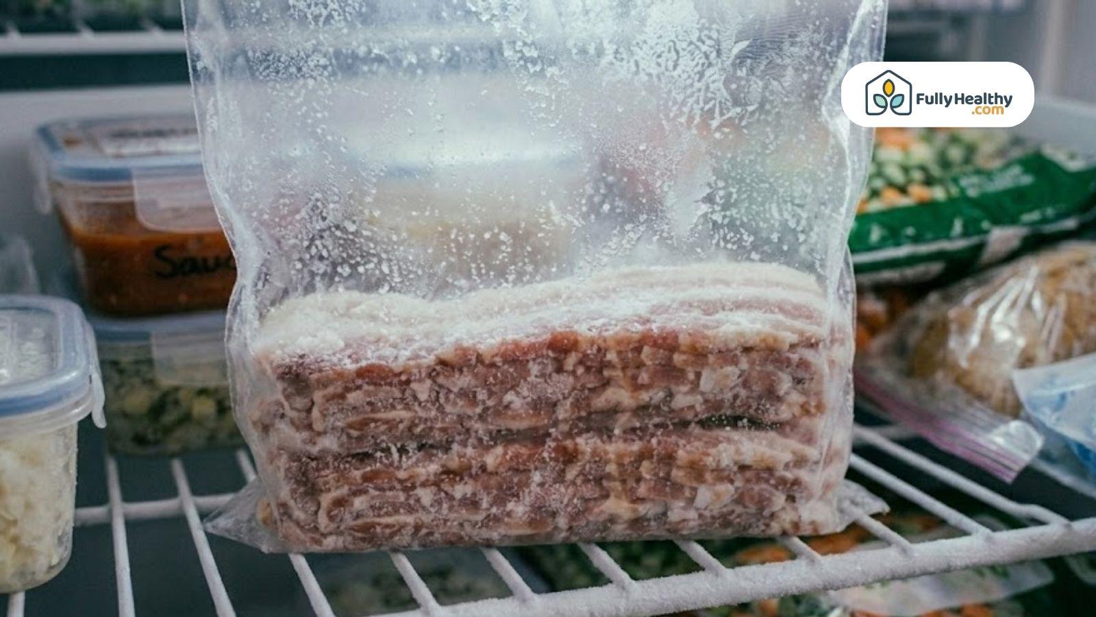 Frozen bacon stored inside a freezer bag on a freezer shelf.