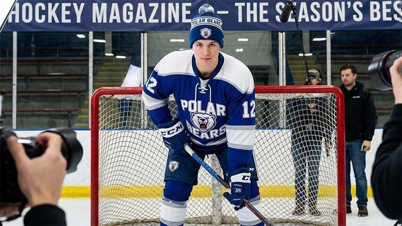 Hockey player wearing a team-branded pom pom beanie