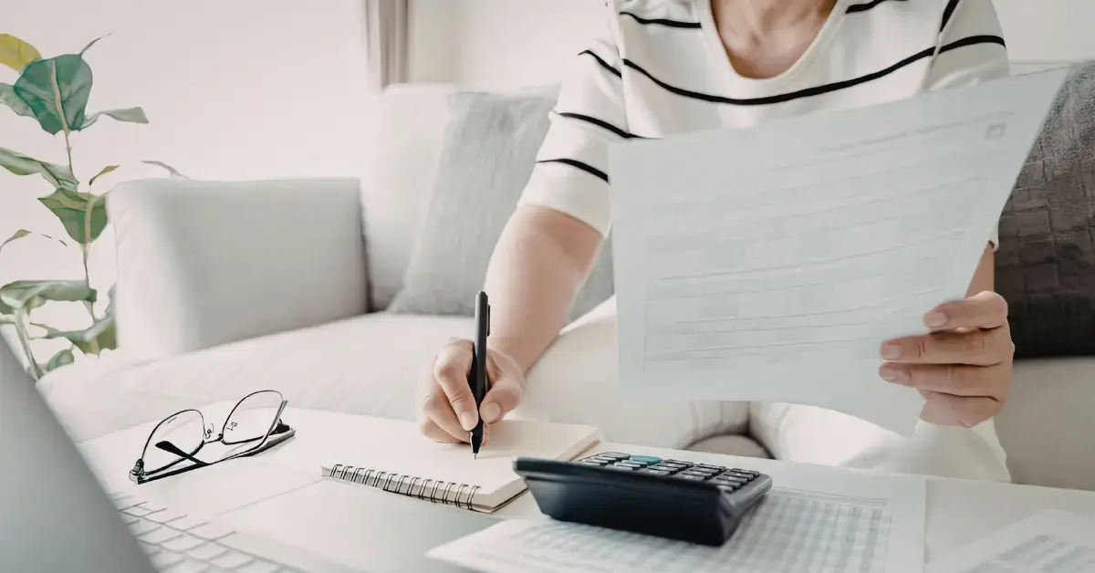 Female OnlyFans creator reviewing tax paperwork and comparing 1120 and 1120S forms.