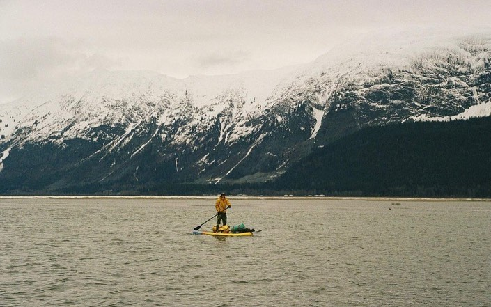 man on inflatable paddle board