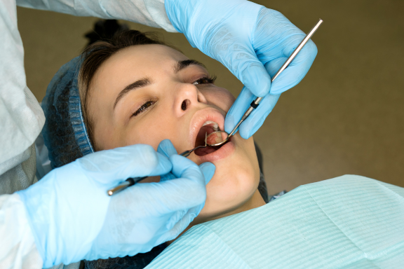 woman in dental clinic gets an exam to remove wisdom teeth