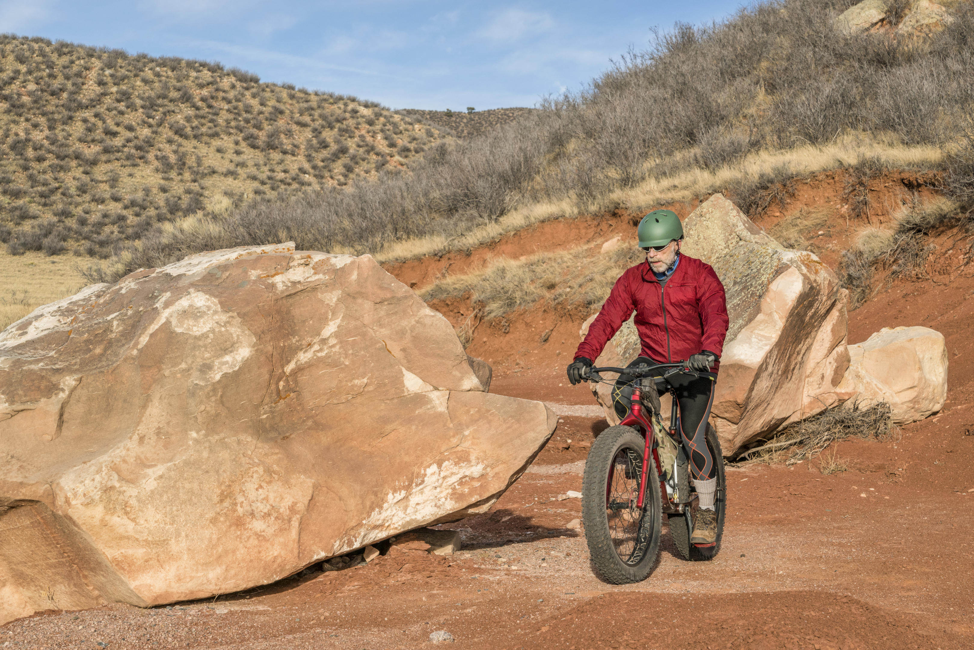 A person riding a fat tyre electric bike on a mountain
