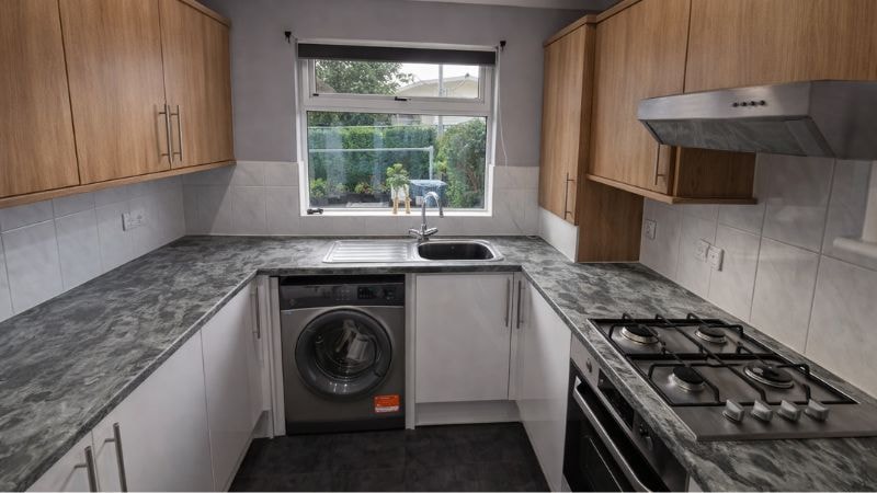 Installation of marble vinyl wrap on countertop of kitchen