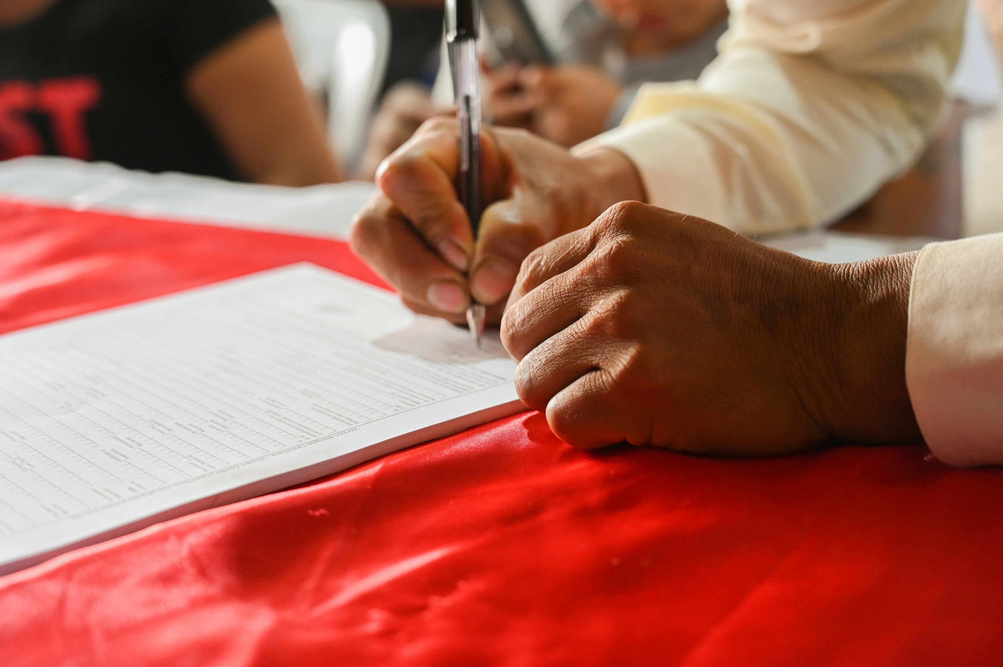 Real estate contractor signs tax paperwork with his accountant.
