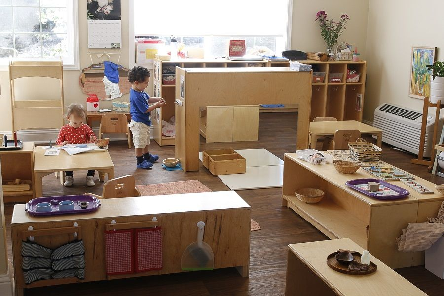 The typical setup of a Montessori classroom where kids can pick up their own activities and play with them