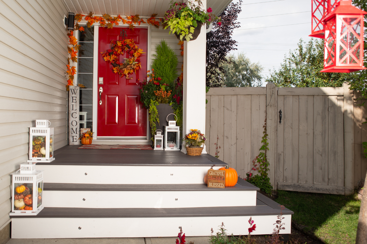 DIY Halloween decorations on a front porch with various spooky elements.