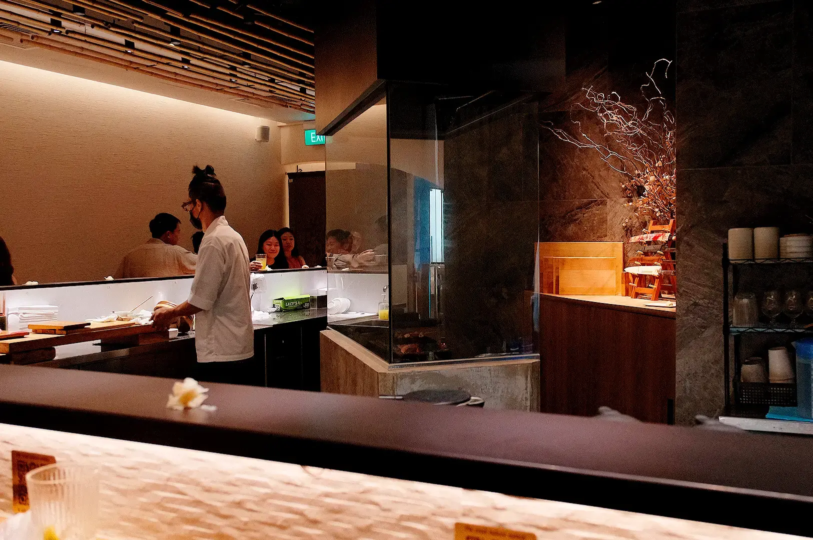 Singapore omakase restaurant interior with sushi chef preparing fresh Japanese cuisine at the counter