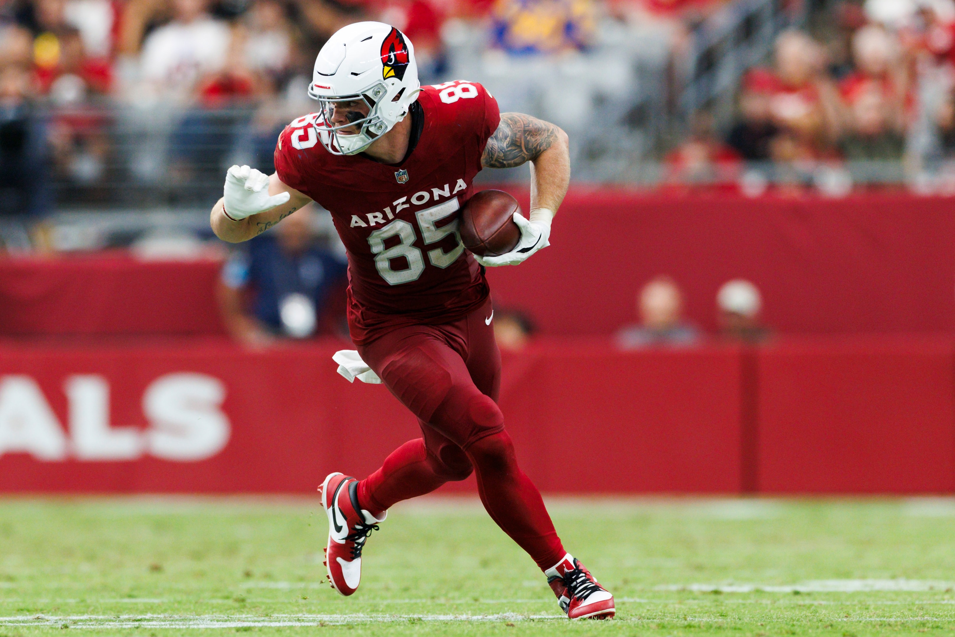 Trey McBride of the Arizona Cardinals runs after a catch during a game at State Farm Stadium on September 15, 2024 in Glendale, Arizona.