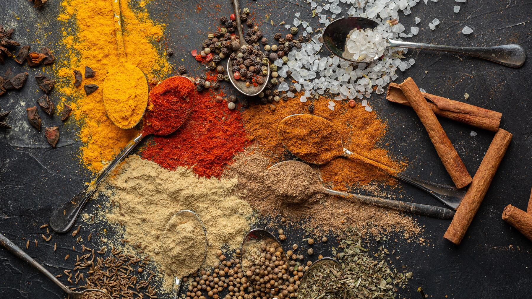 Curry spices: A colourful array of spices including turmeric, cumin, coriander, and chili powder.