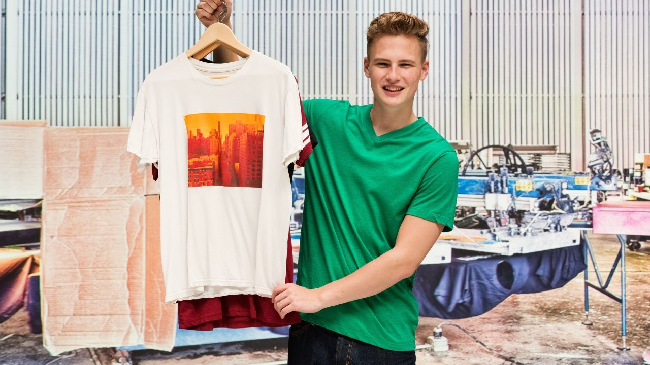 A person holding a t-shirt with a custom print on demand design