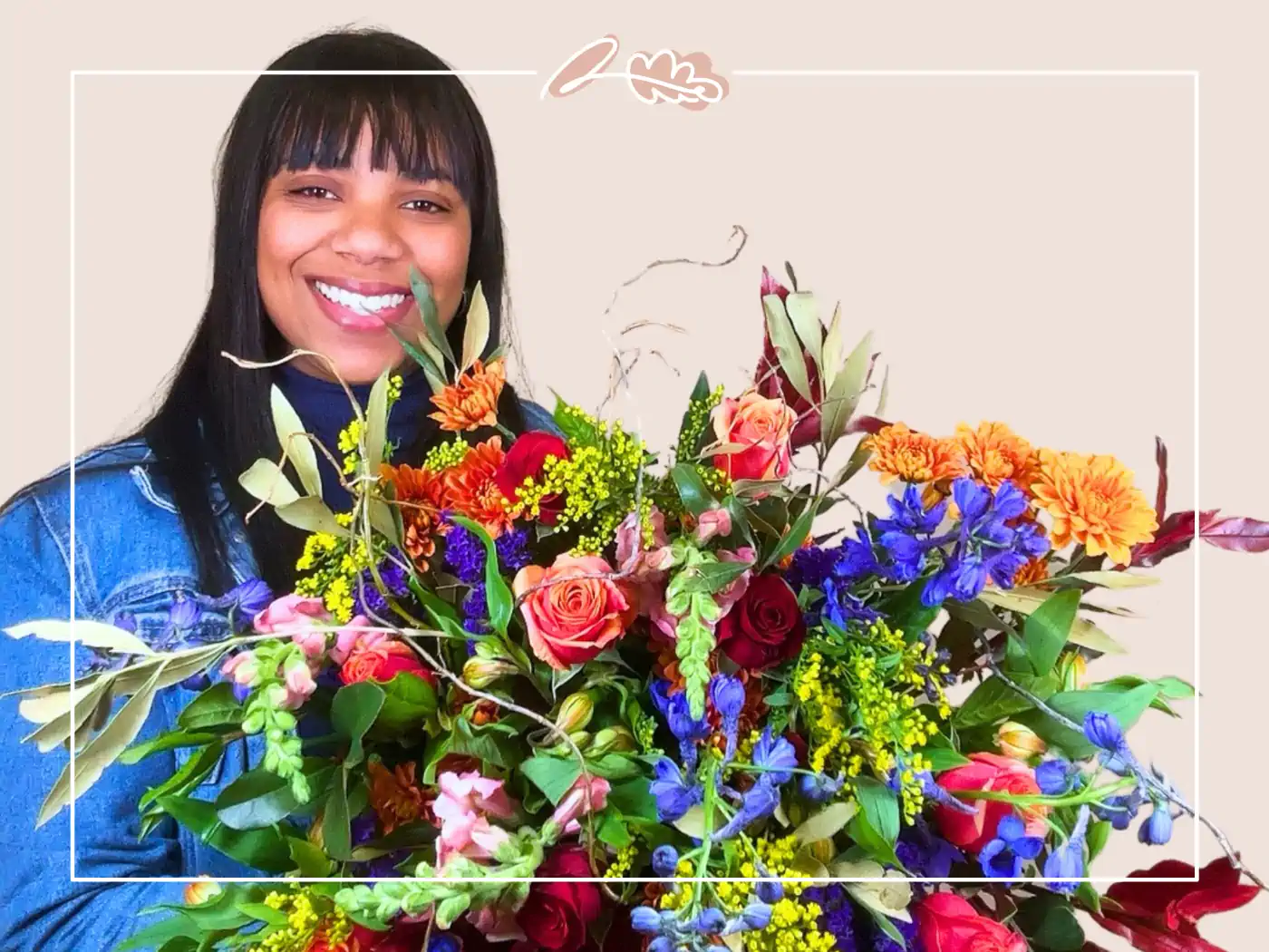 Smiling woman holding a colorful bouquet of orange, blue, red, and green flowers. Fabulous Flowers and Gifts