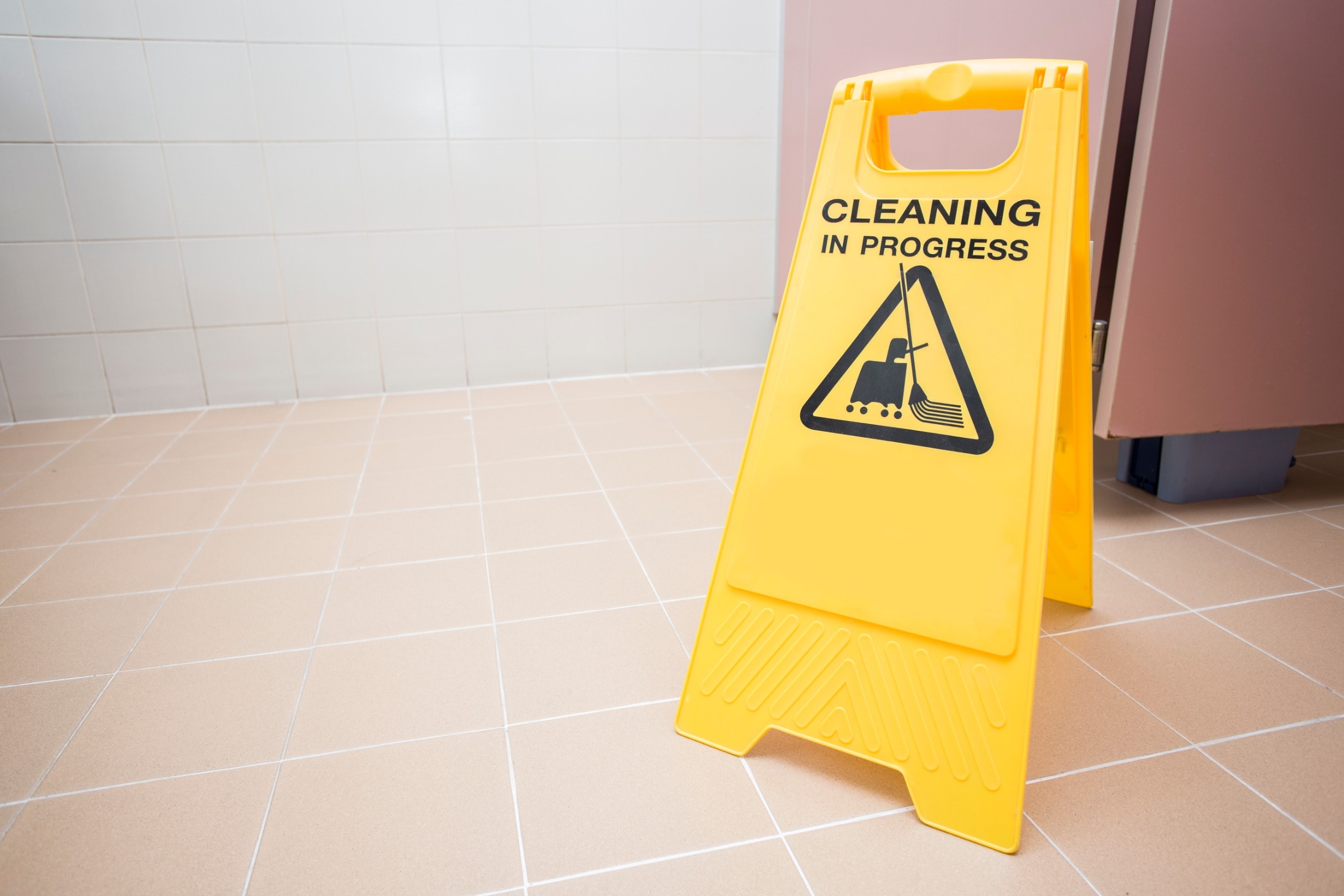 A wet floor sign on a tiled floor to prevent the risk of personal injury