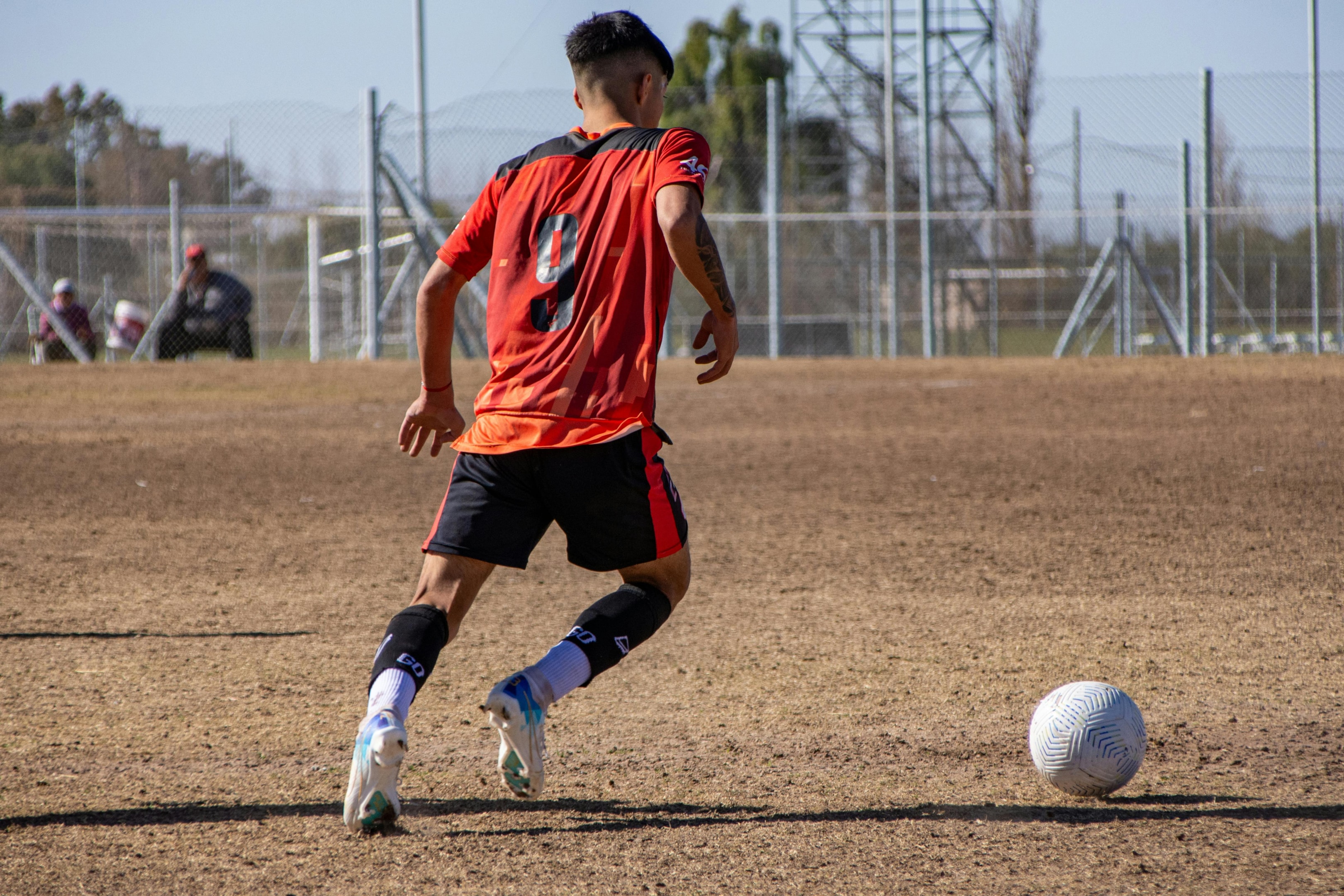 Photo by Franco Monsalvo: https://www.pexels.com/photo/a-man-in-an-orange-shirt-is-playing-soccer-27532428/