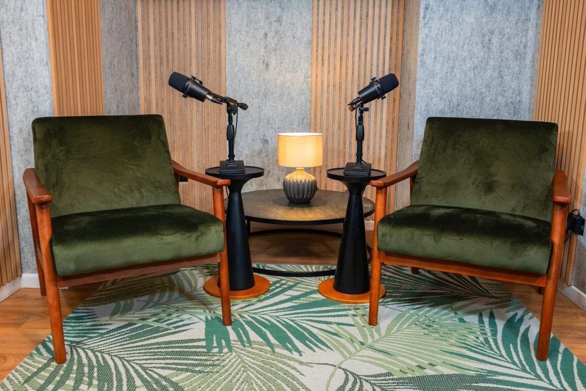 Premiere Podcast Studios in London, two green chairs in a bright recording studio