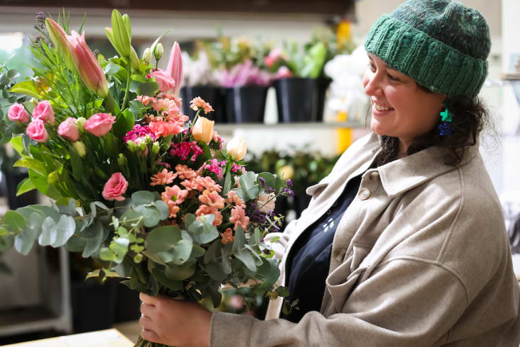 A skilled florist creating a beautiful flower arrangement