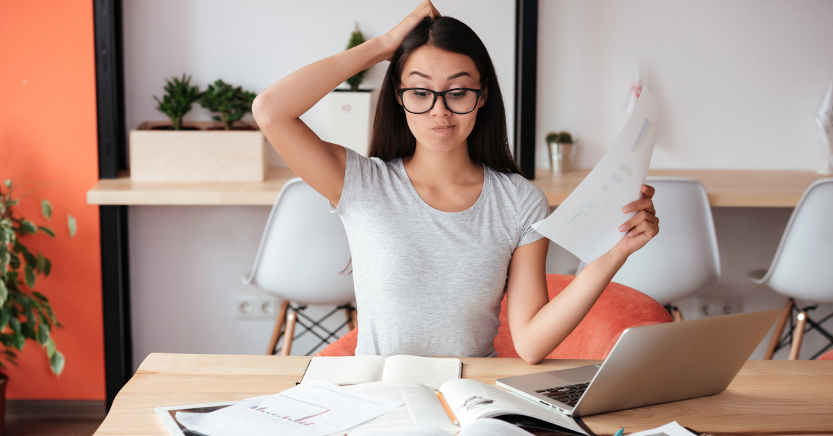 A woman researching what is the difference between sole proprietor and LLC to optimize her OnlyFans taxes.
