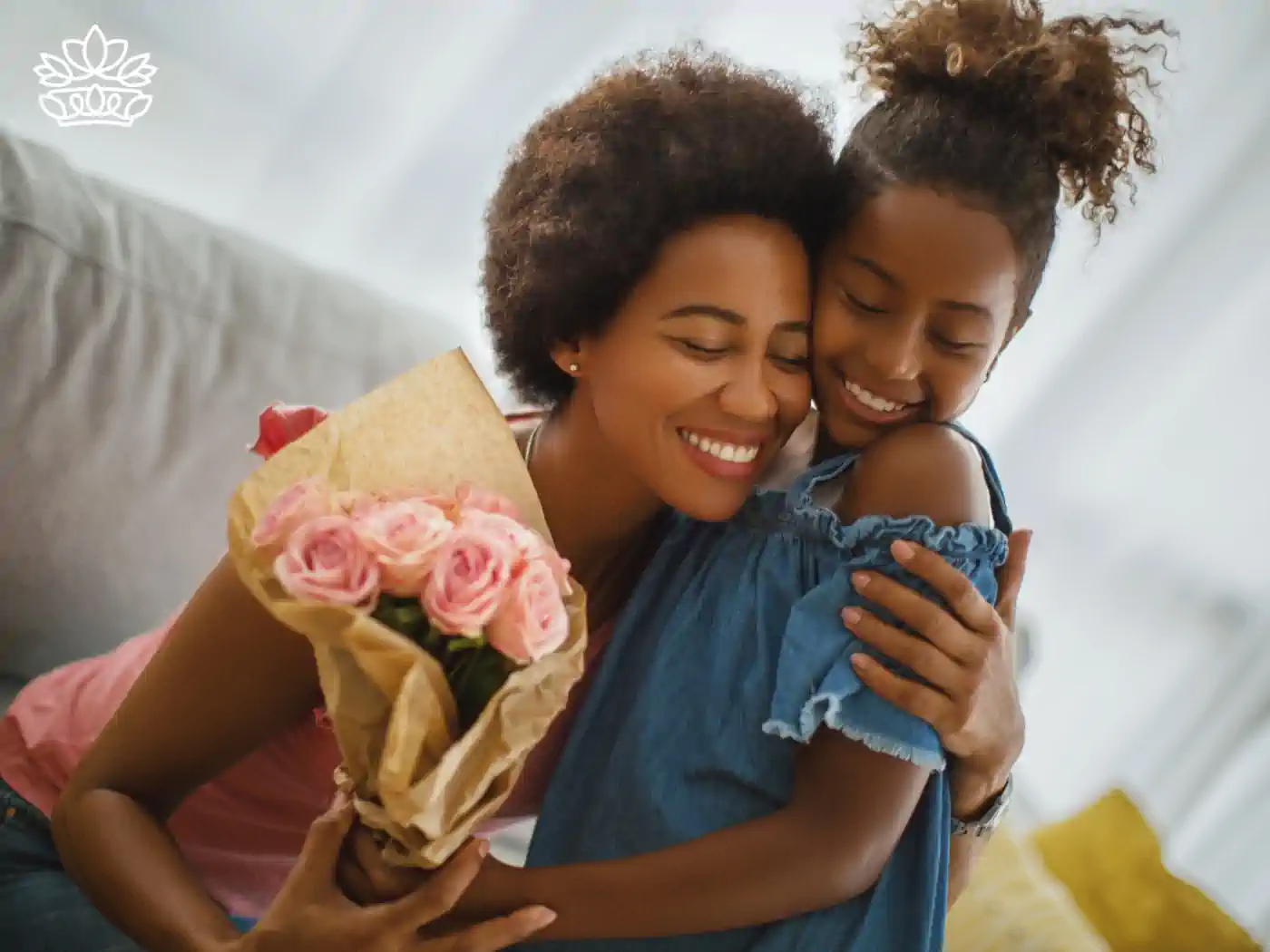 A joyful mother hugging her daughter while holding a bouquet of pink roses. Fabulous Flowers and Gifts. Mother's Day Flowers.