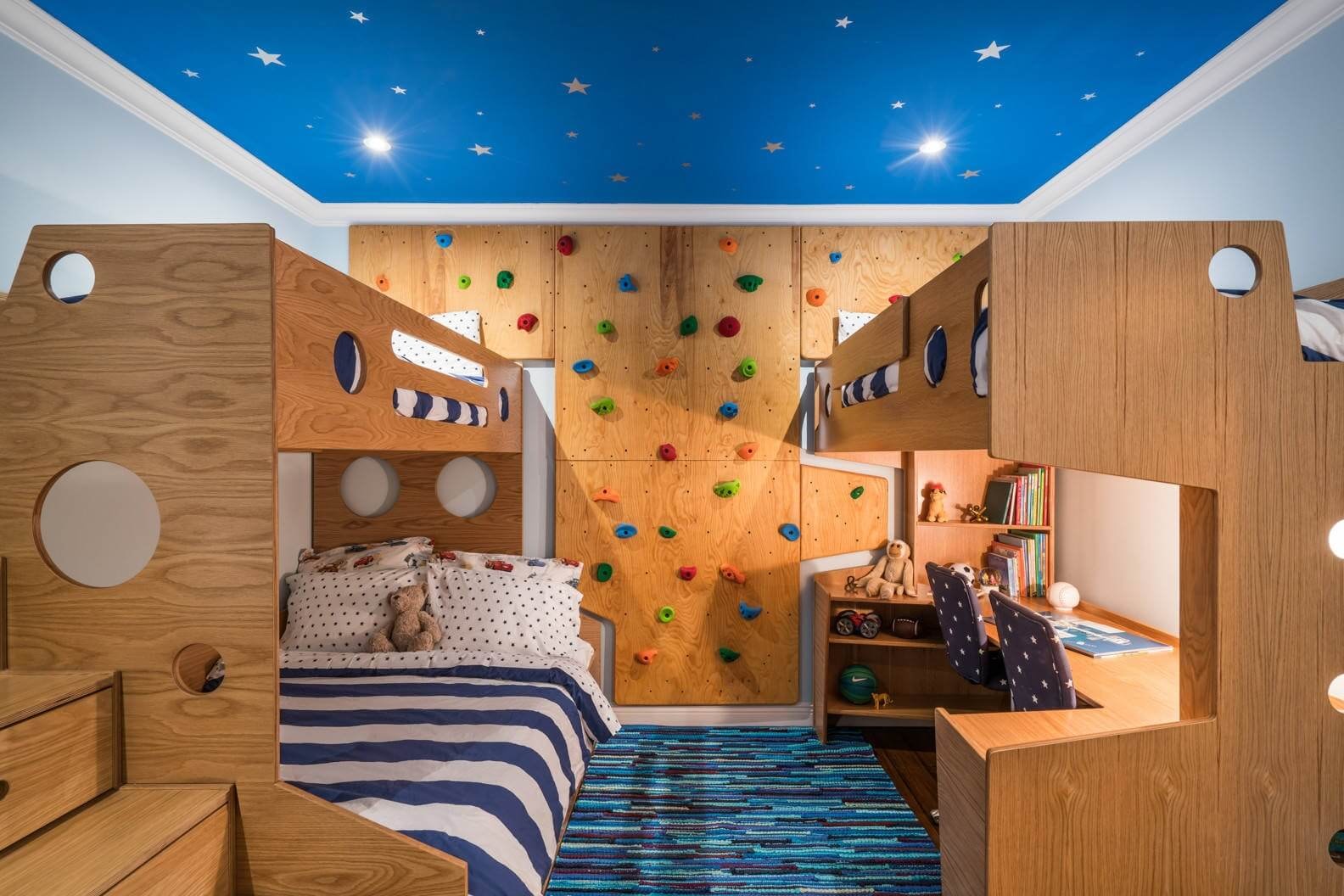 A modern loft bed is showcased in a small boys bedroom