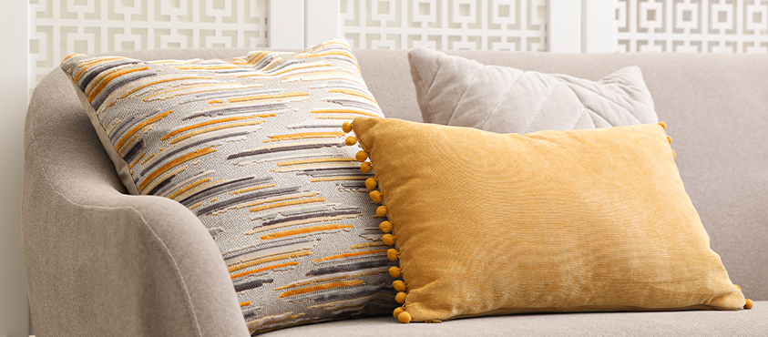 A knife edge pillow gives a clean line, while decorative trims such as a pom pom trim give an elegant flourish.