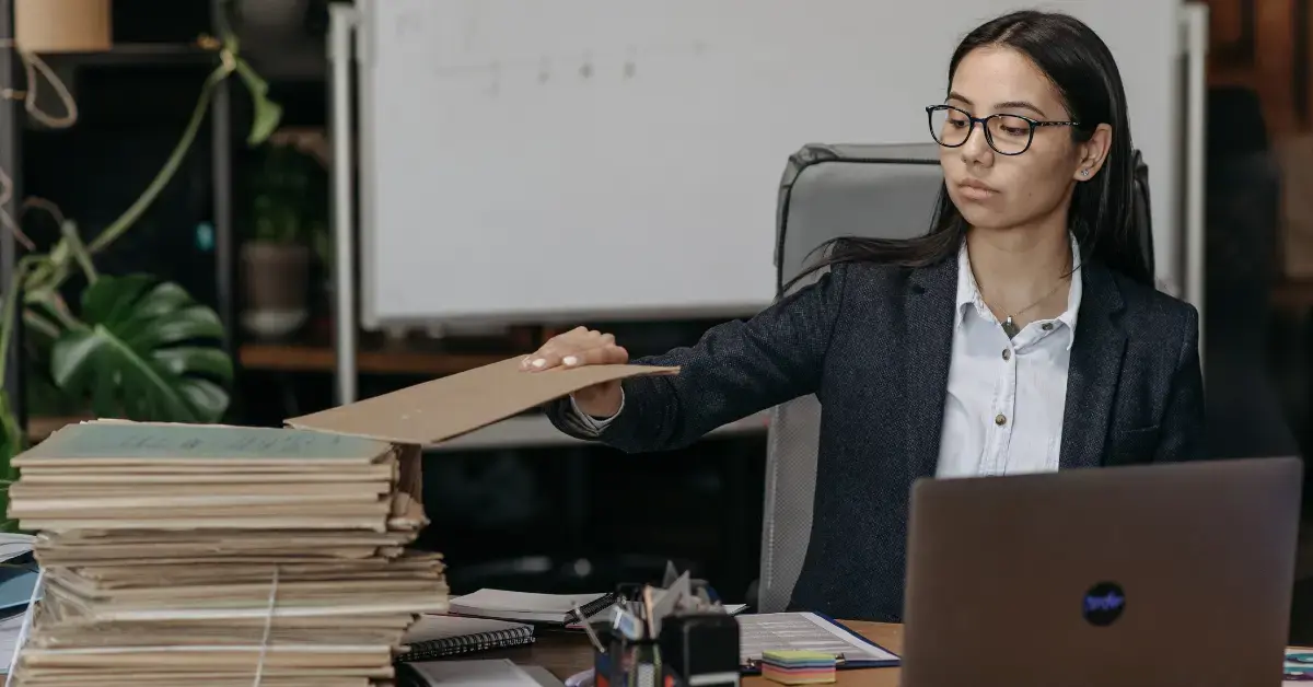 Woman reviewing tax records to understand how far back can the IRS audit her tax returns.