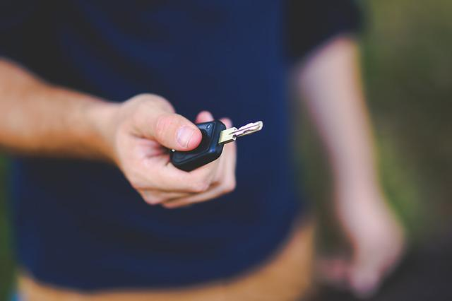 Man holding car keys, ownership transfer concept