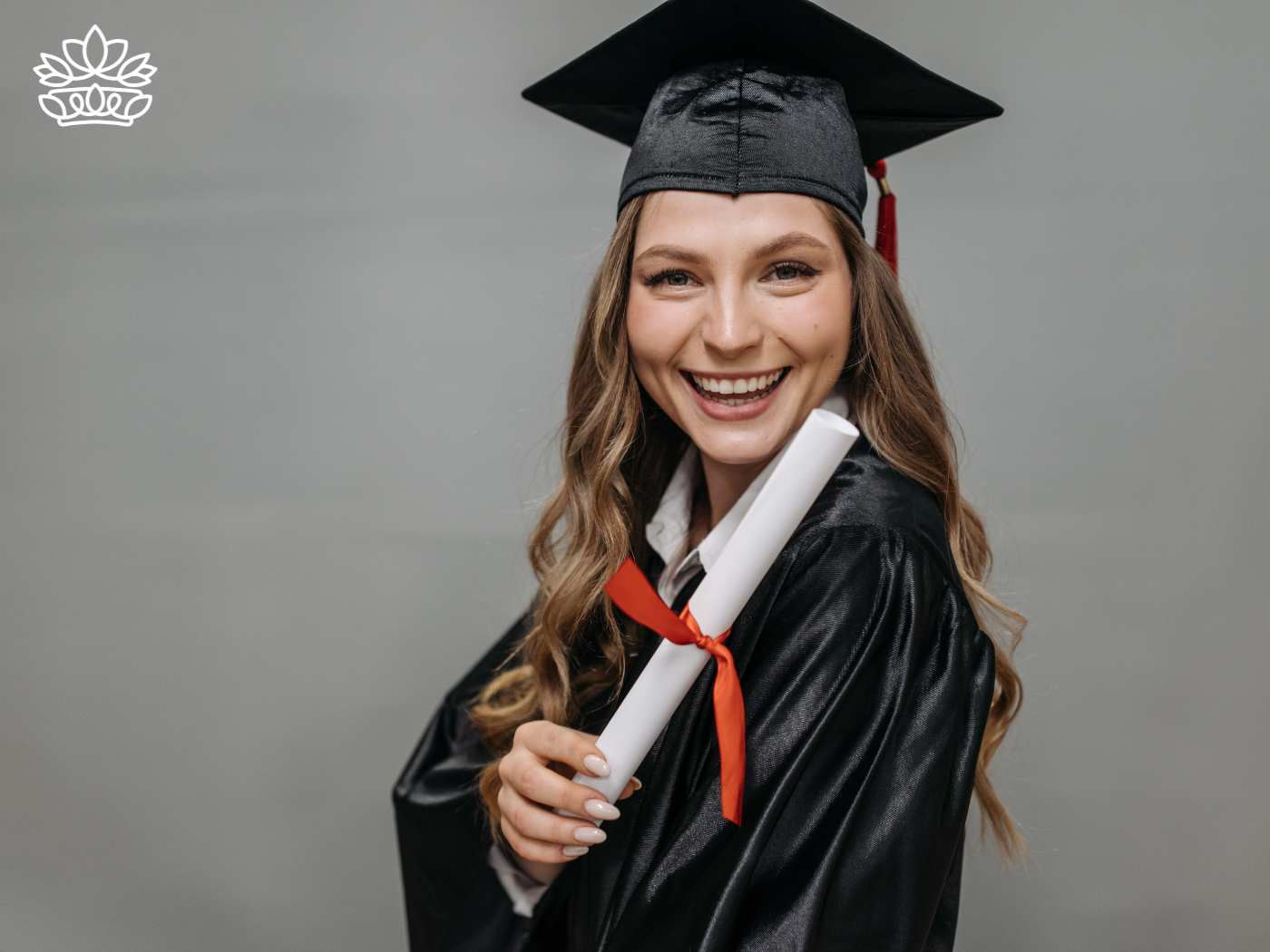 A radiant female graduate in academic regalia, holding her diploma with a red ribbon, smiling broadly, captured by Fabulous Flowers and Gifts, celebrating her success and graduation delivered with heart