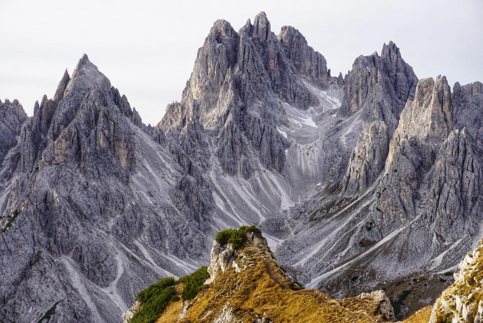 A hike viewpoint with jagged mountain peaks in the background in the Dolomites, Italy