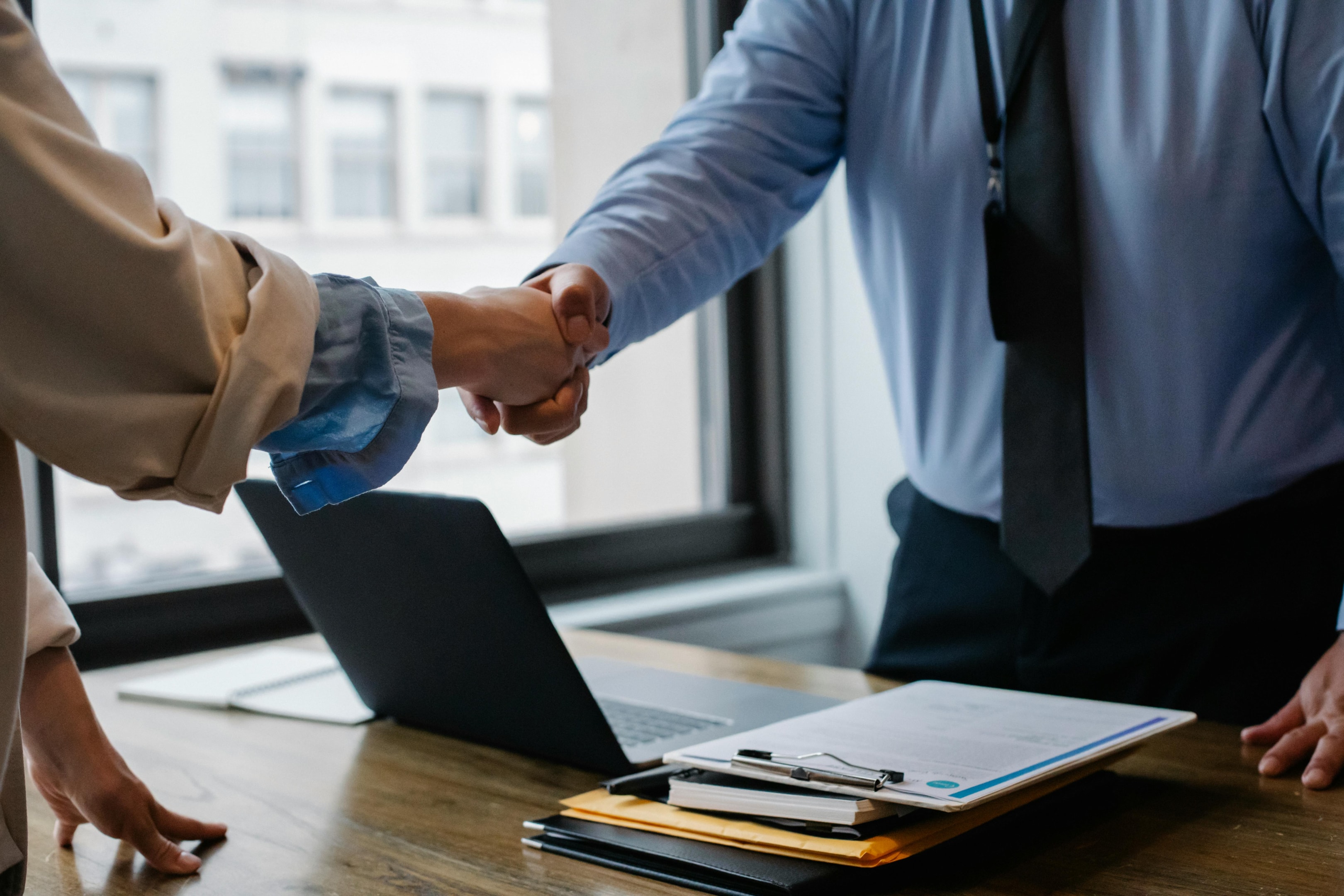 Handshake between investor and client after successful deal. 