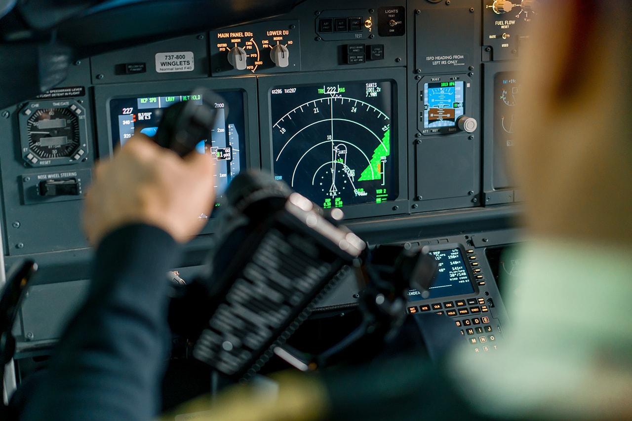 FAA-certified pilot reviewing pre-flight checklist in cockpit