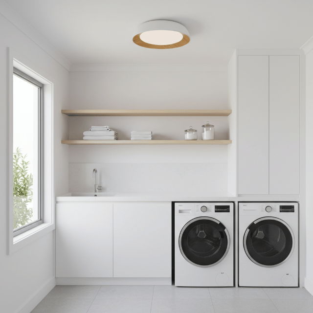 Minimalist flush-mount ceiling light with wood accent illuminating a modern laundry room.