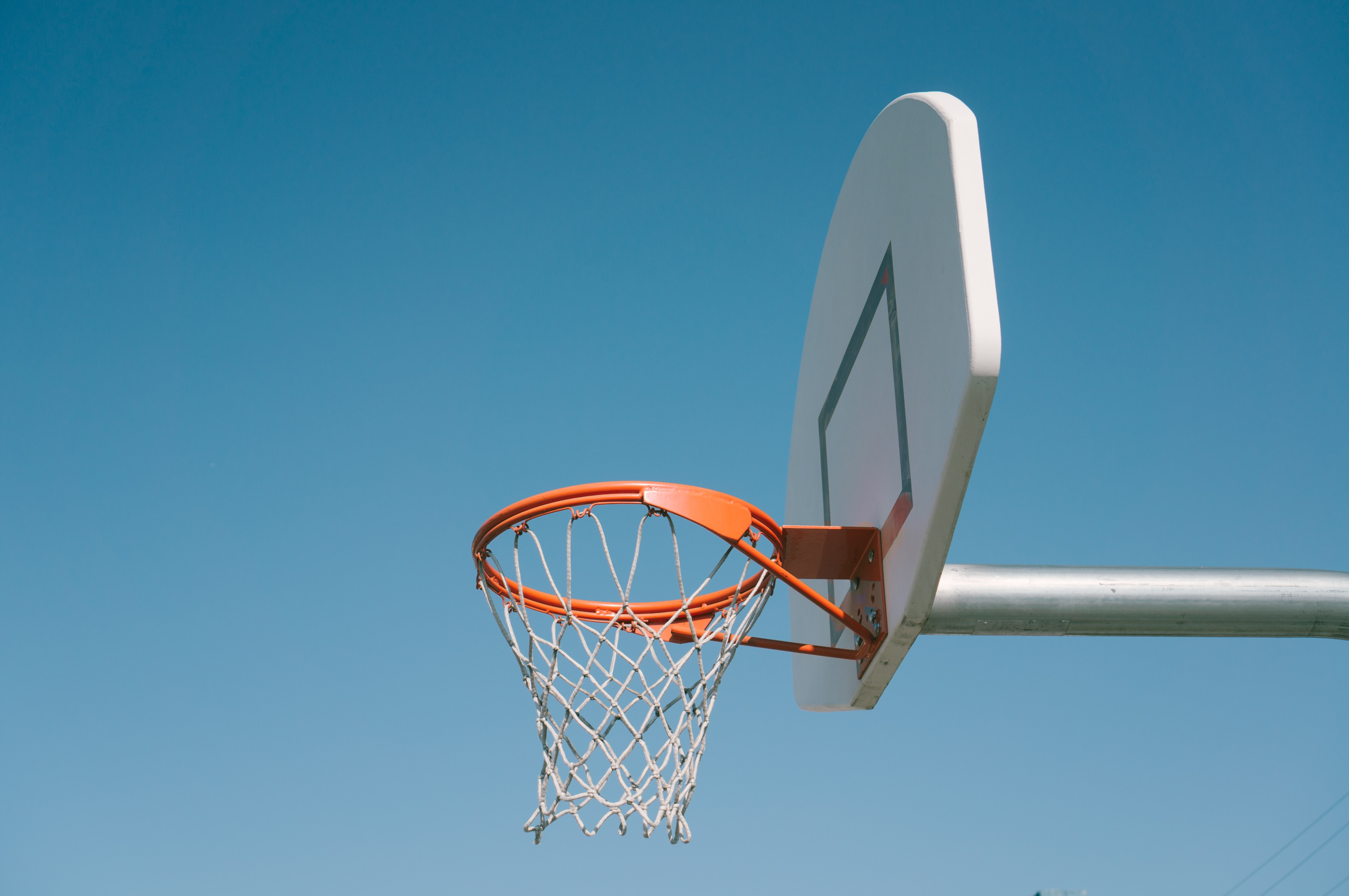Outdoor basketball hoop, net, and backboard