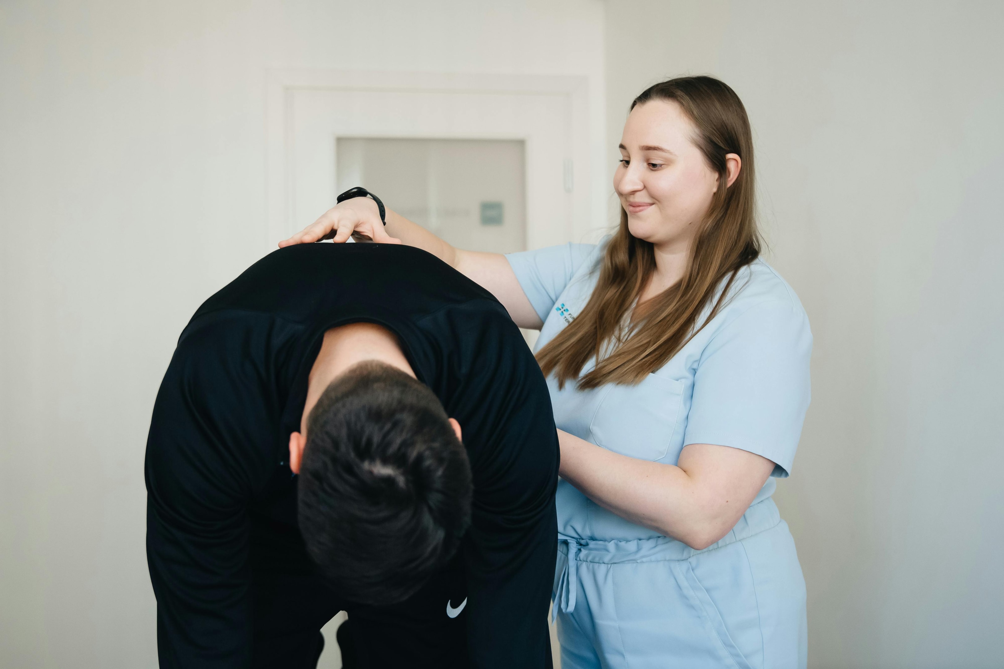 Photo by Funkcinės Terapijos Centras: https://www.pexels.com/photo/bent-over-patient-examined-by-a-physiotherapist-20860590/