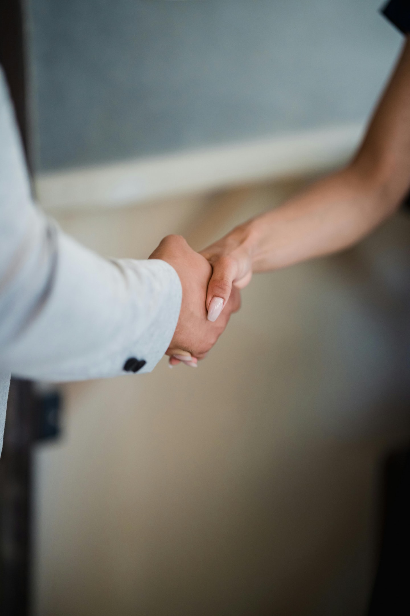 Real estate investor shakes hand of motivated seller. 