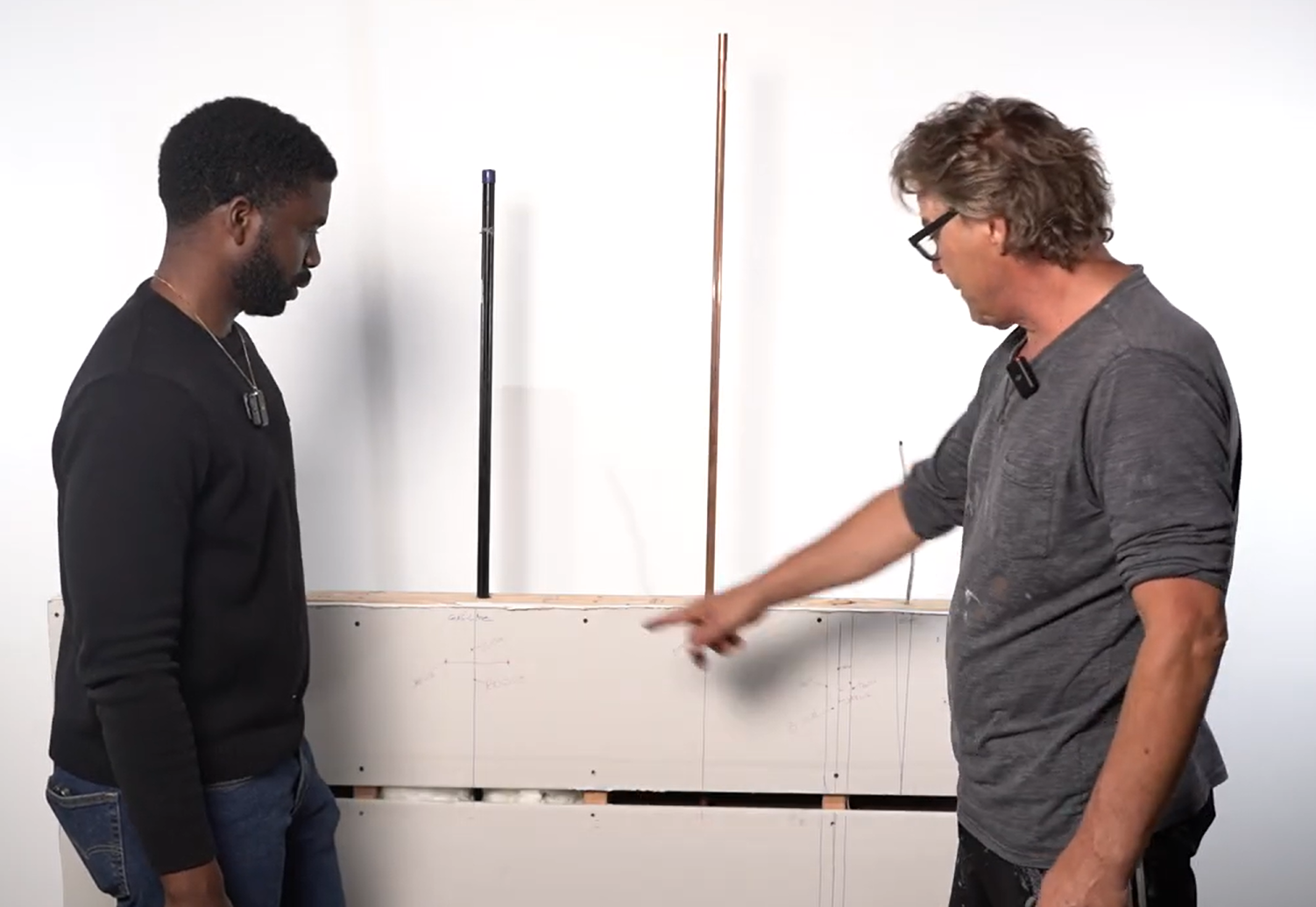handyman showing how the mock wall was created