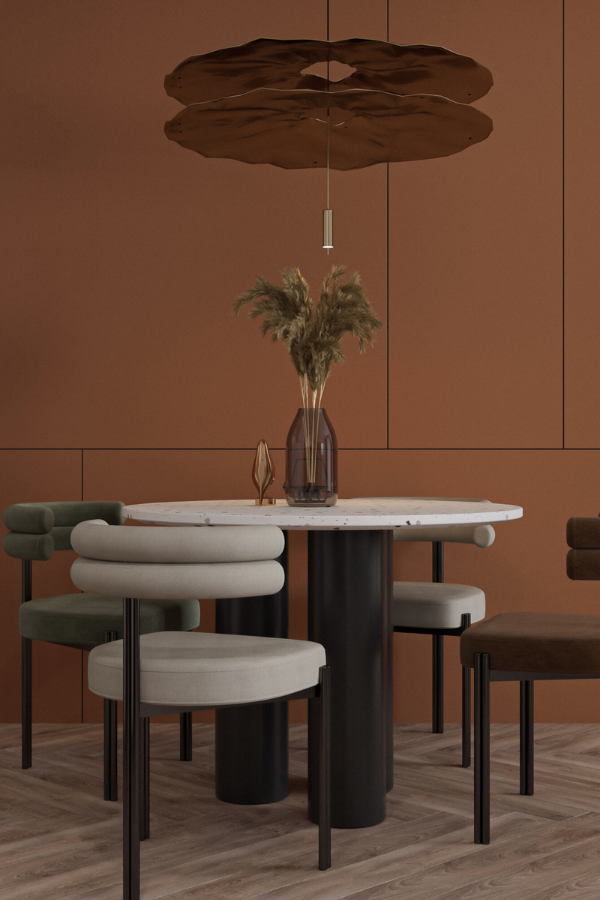 white, brown, and sage green chairs around a terrazzo table with a bold pendant light overhead