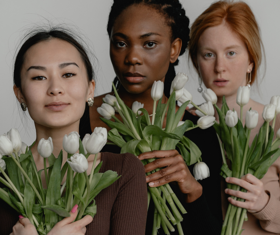 three women with flowers think about how to make friends as an adult