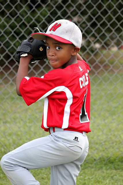 youth baseball player warming up to pitch