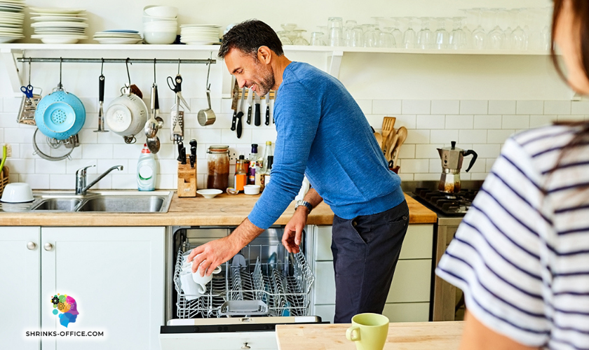 A man putting away the dishes in a post about How to Help Wife With Postpartum Depression