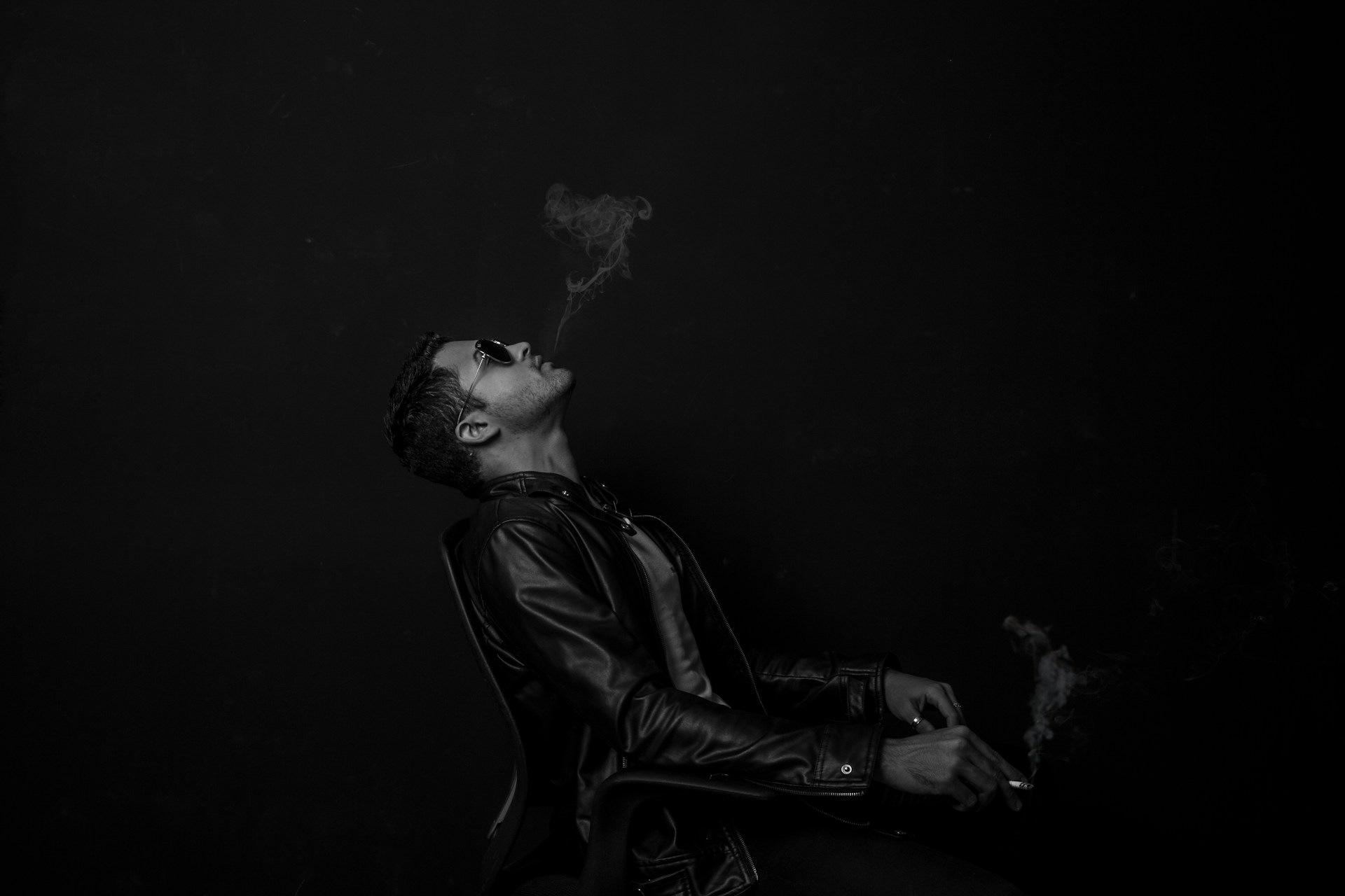 A black and white photo of a cool dude smoking, despite it known for lowering his semen volume