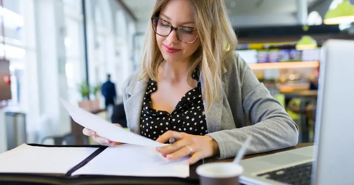 Woman reviewing tax documents and IRS correspondence while learning what is a CP2000 notice.