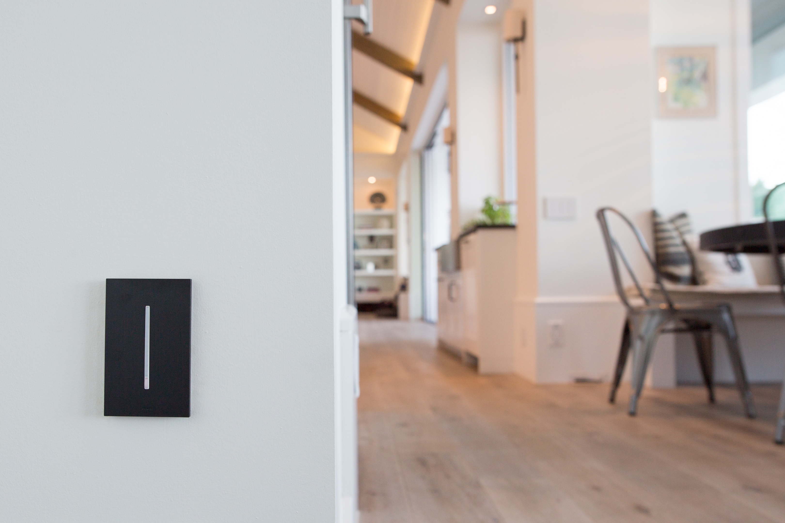 An image of an occupancy sensor installed in a residential space, highlighting the benefits of smart lighting in residential spaces by automatically turning off lights when the room is unoccupied.
