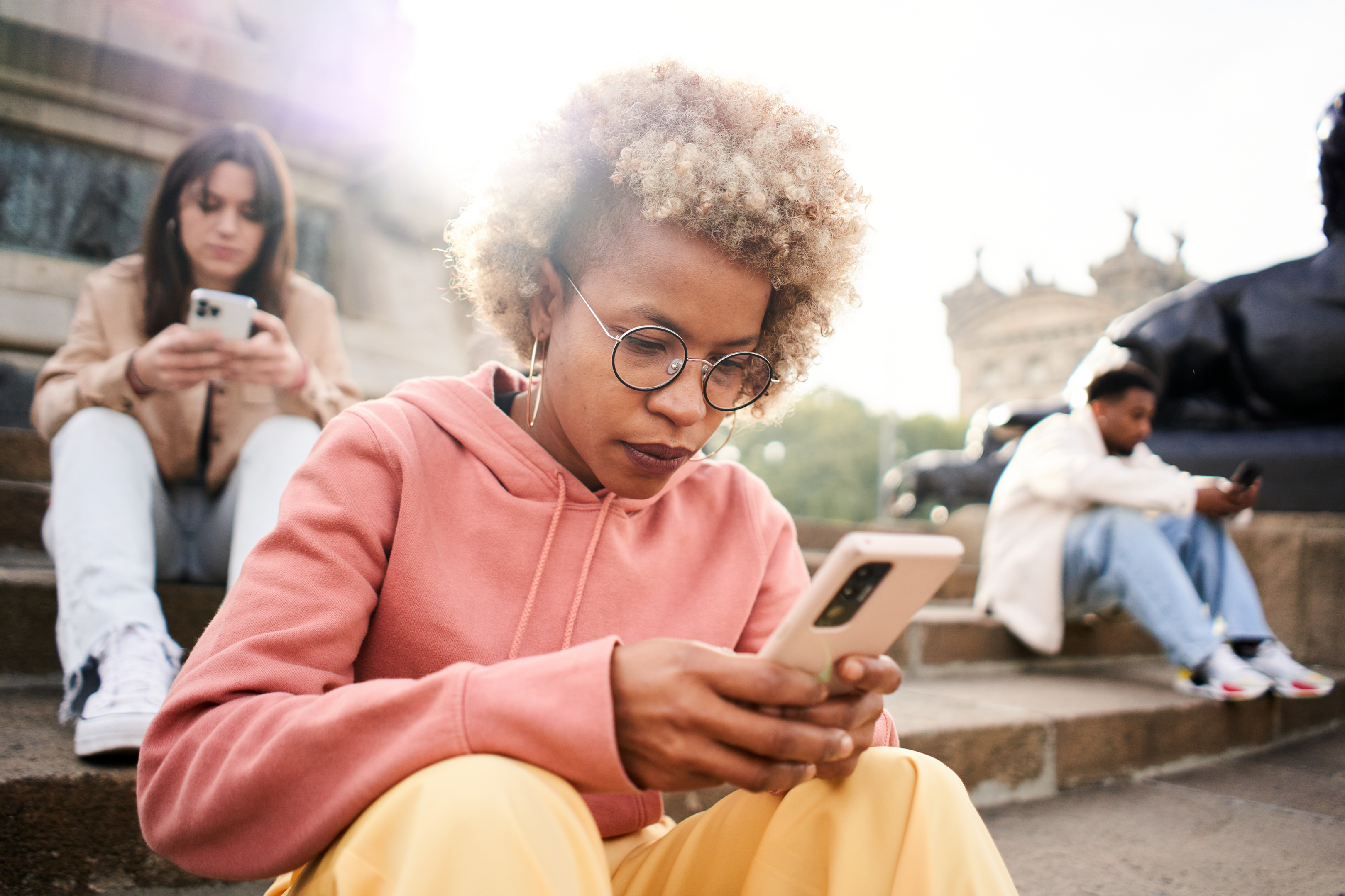 Different people using mobiles