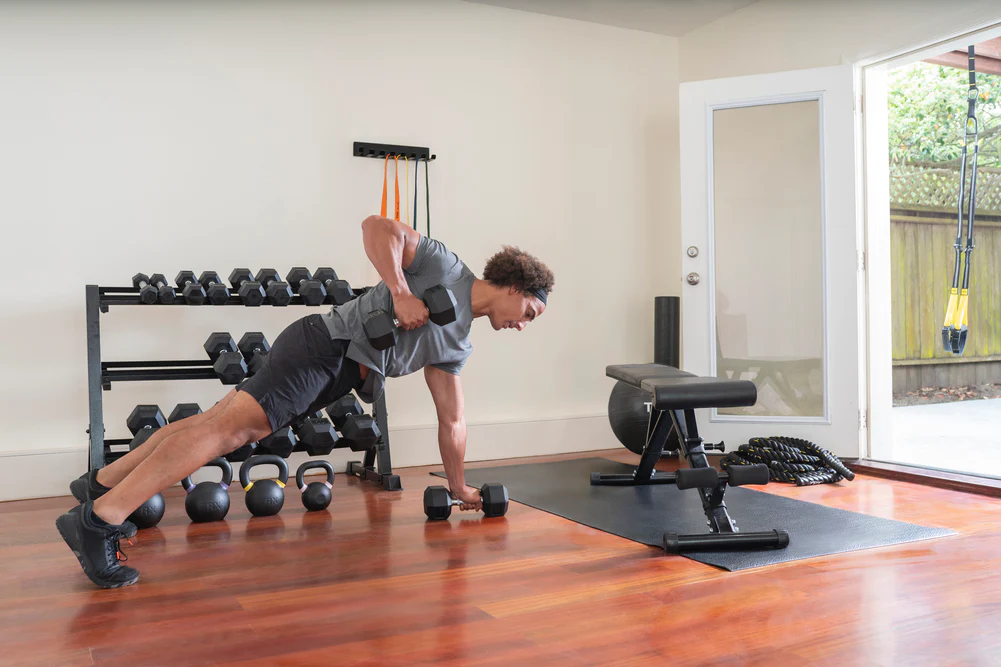 A person exercising with actual dumbbells, and standard dumbbells