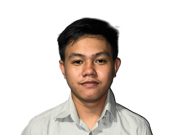 A young man in a light gray collared shirt poses for a professional headshot against a white background, wearing a calm, composed expression — suggestive of a profile photo or ID portrait.